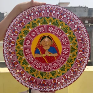 Add a touch of tradition to your home with this hand-painted Aipan Wall Plate made on premium MDF board. Featuring a vibrant “Namaste” lady design and intricate Uttarakhand Aipan patterns, this lightweight and durable décor piece is perfect for entrances, living rooms, pooja rooms, and gifting.